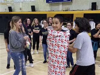student wrapped in gift paper