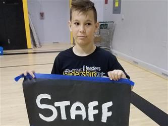 student holding staff sign