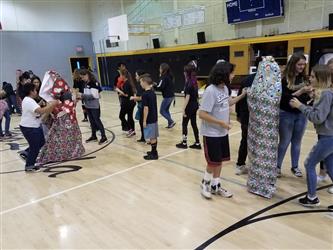 students getting wrapped in gift paper