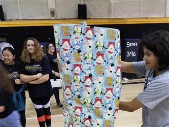 students holding gift paper