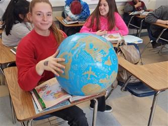 student holding globe