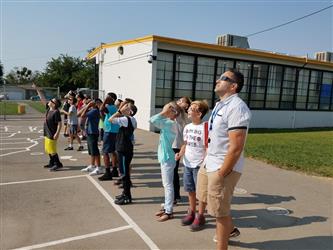 students wearing solar viewing glasses