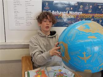 student holding globe