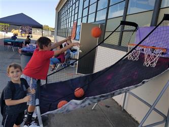 students shooting basketball