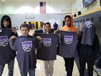 people in gym holding sacramento kings shirts