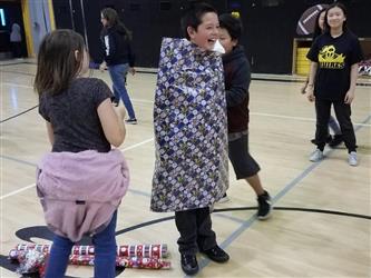 student wrapped in gift wrap