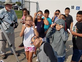 students wearing solar viewing glasses