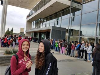 students lined up in front of building