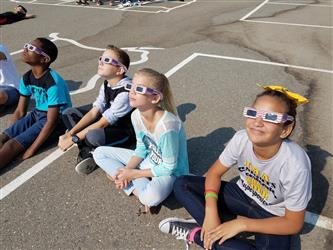 students wearing solar viewing glasses