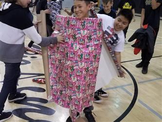 student wrapped in gift wrap