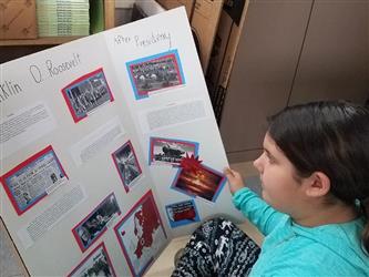 student looking at trifold display board