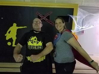 teacher flexing and other teacher with cape