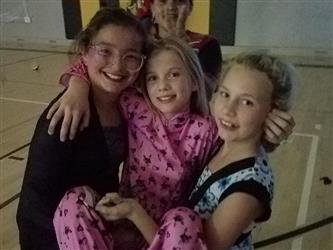 students holding other student in arms