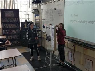 students at front of class, giving presentation