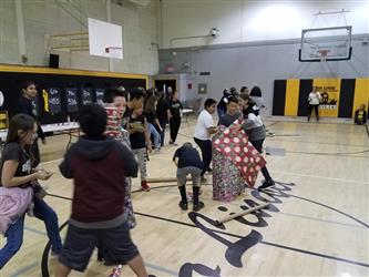 students in line running to wrapping paper
